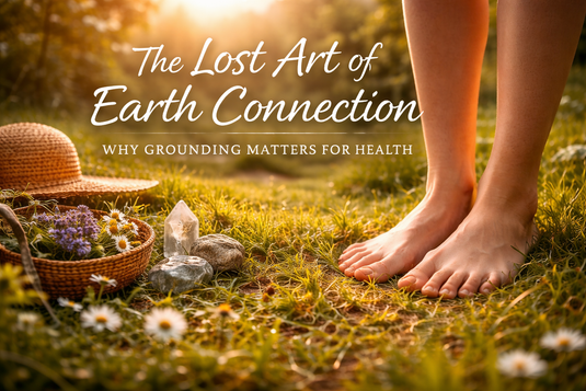 Bare feet grounding on grass at sunrise with herbs and crystals, symbolizing earthing, nature connection, and holistic wellness practices.
