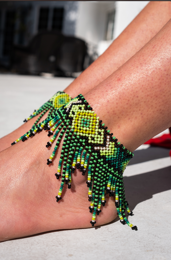 Pair of handcrafted exotic ankle bracelets with intricate tribal beadwork and geometric patterns, made by Brazilian artisans using traditional techniques.