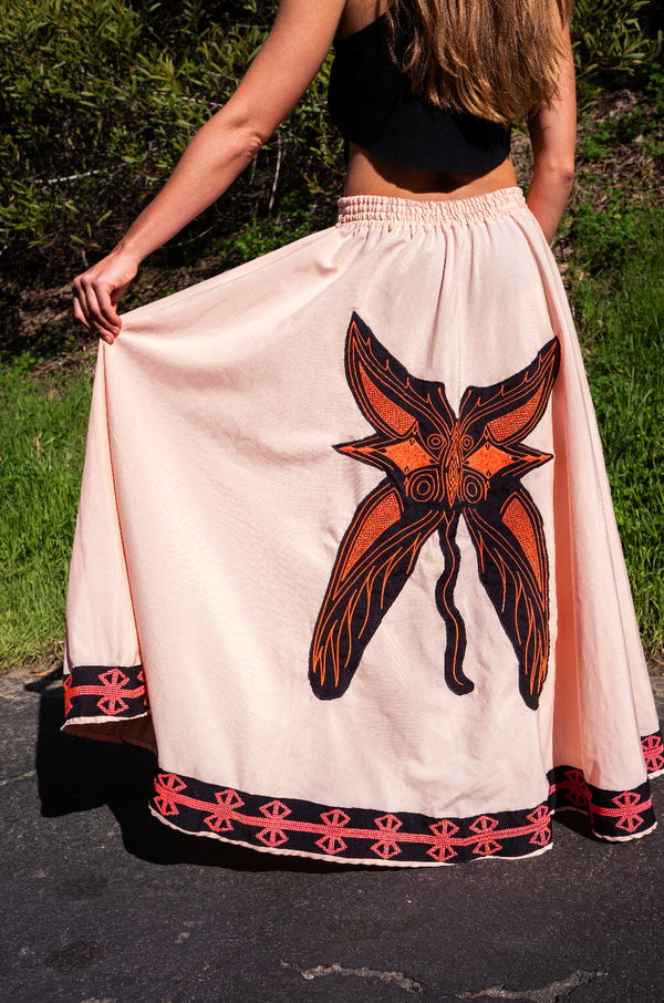 Hand-embroidered tribal skirt with butterfly spirit motif and sacred coral geometric patterns, crafted by indigenous artisans as a 1-of-1 ceremonial garment.