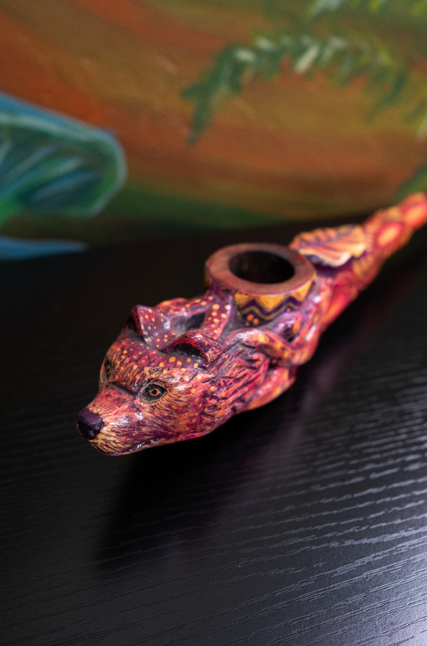 Hand-carved Fox Spirit ceremonial pipe with vibrant jaguar and serpent motifs, crafted in the Amazon using natural pigments for sacred rituals and altar display.